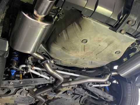 Custom stainless steel exhaust system fitted to a car on the hoist